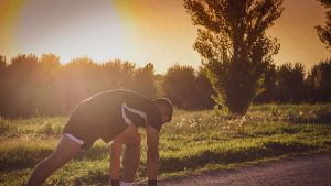 a person bending over on a road