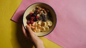 A vibrant oatmeal bowl with fruits and nuts on a pastel background, perfect for healthy breakfast ideas.